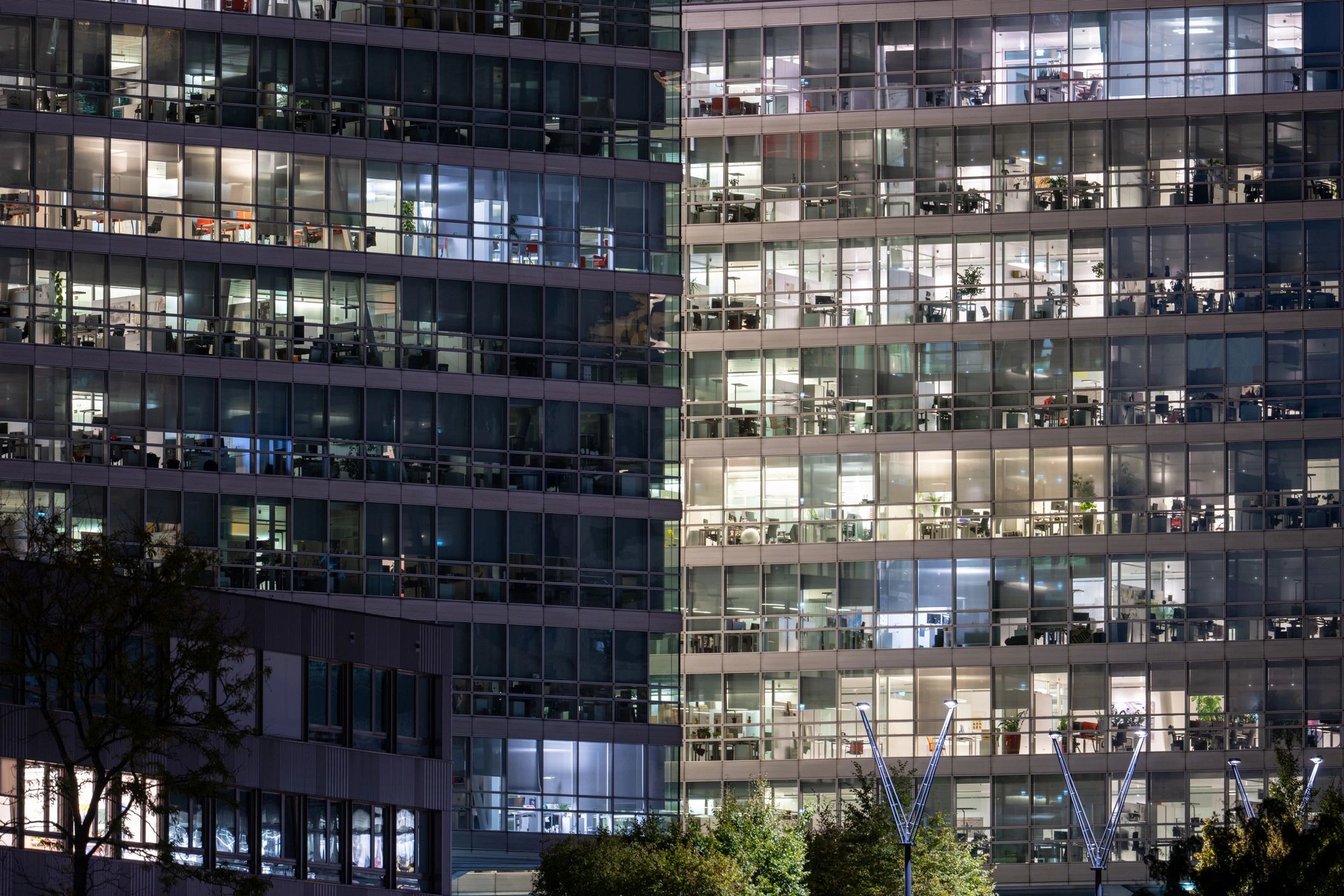 Modern glass office building with illuminated windows